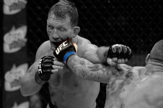 Gray Maynard, a former UFC fighter, getting punched in the face during a bout in 2014. Maynard is now automatically part of a class-action antitrust lawsuit against the UFC.